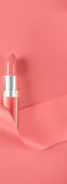 Luxury lipstick and silk ribbon on coral holiday background, mak - 写真・画像