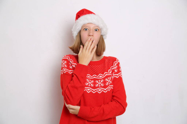 Santa hat on teen girl on Christmas theme - Фото, зображення