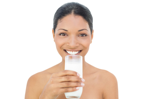 Cheerful black haired model holding glass of milk - Foto, Bild