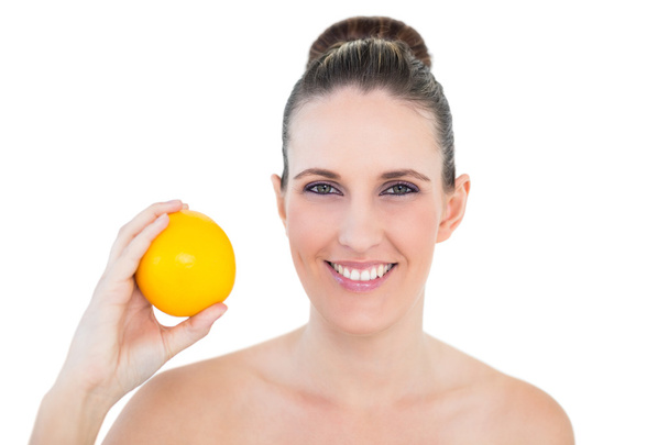 Happy woman holding orange - Zdjęcie, obraz