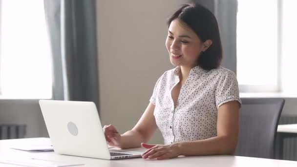 Asian woman employee having informal conversation video call in workplace - 映像、動画