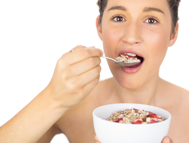 Smiling healthy model eating cereals - Φωτογραφία, εικόνα