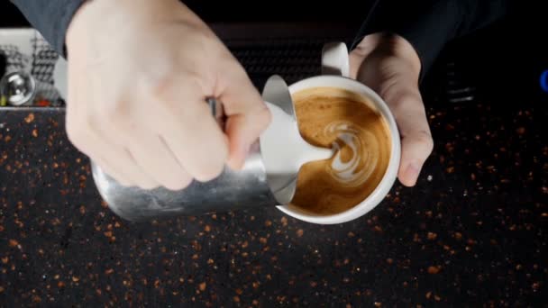 Coffee making video. Barista pouring hot milk in white cup making cappuccino. Close up. Bartender preparing morning coffee. Slow motion. hd - Footage, Video