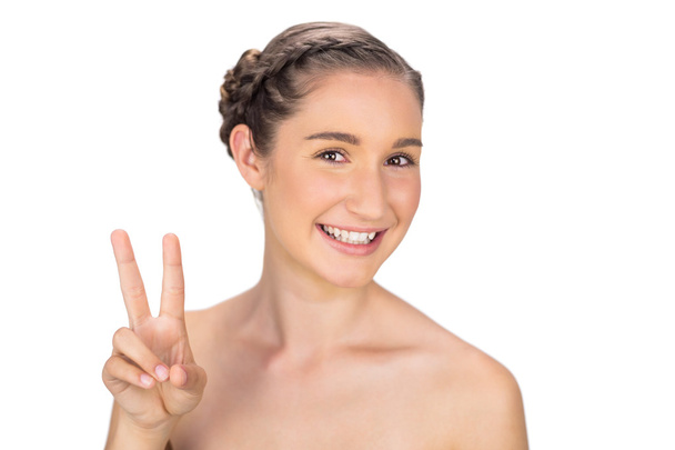 Smiling woman making peace and love gesture - Fotoğraf, Görsel