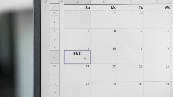 Zapisuje se schůzka Bussines 14. na kalendář pro zapamatování tohoto data. - Záběry, video