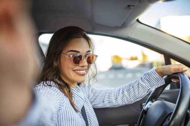 Beautiful young woman on passenger seat in car, taking selfie. Carfie (selfie in the car). Beautiful young woman in car. Beautiful woman making self portrait at car - Foto, afbeelding