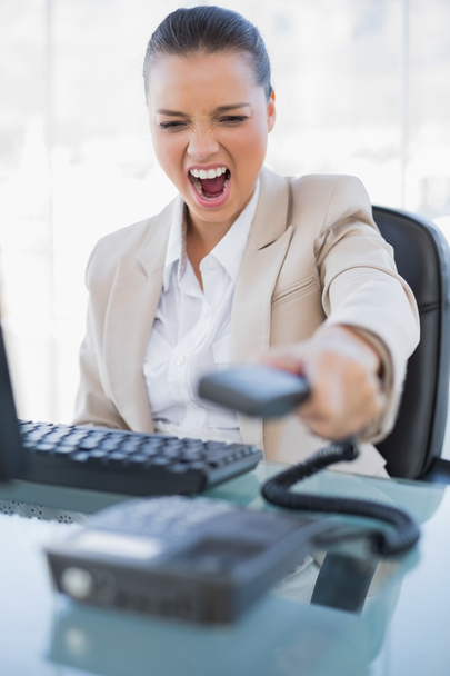 Angry businesswoman screaming while hanging up the phone - Foto, immagini