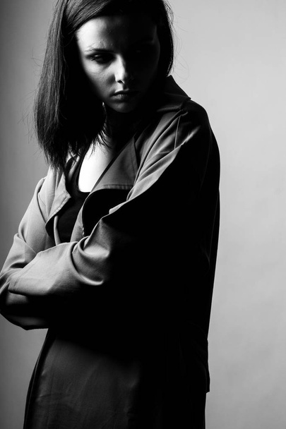 beautiful young girl in a trench coat, black and white  - Fotografie, Obrázek