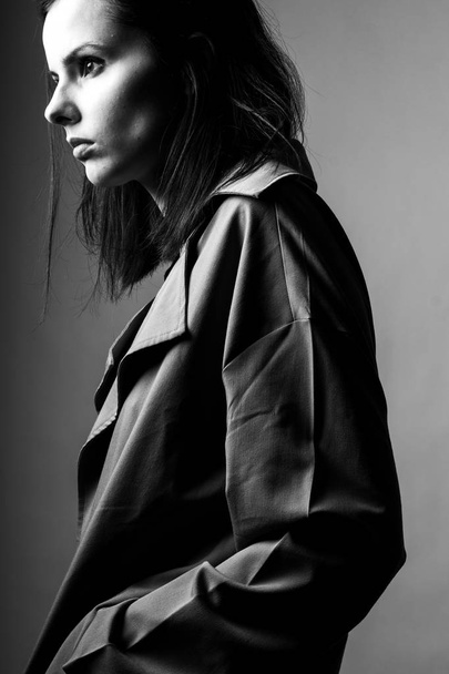 beautiful young girl in a trench coat, black and white  - Zdjęcie, obraz