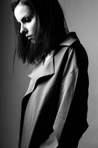 beautiful young girl in a trench coat, black and white  - Fotografie, Obrázek