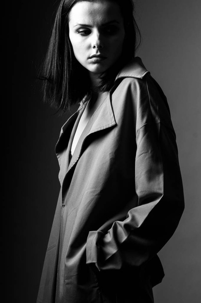 beautiful young girl in a trench coat, black and white  - Photo, image
