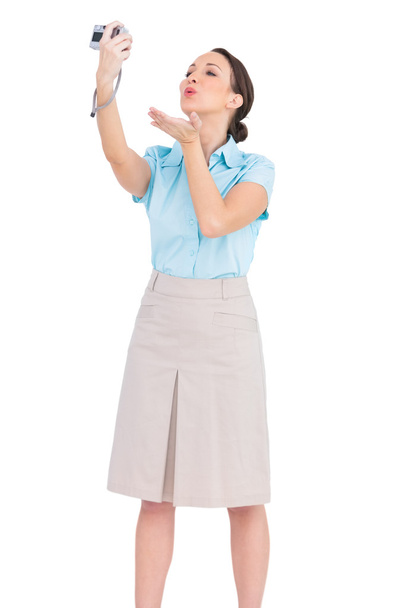 Cheerful classy businesswoman sending a kiss while taking picture - Foto, Imagem
