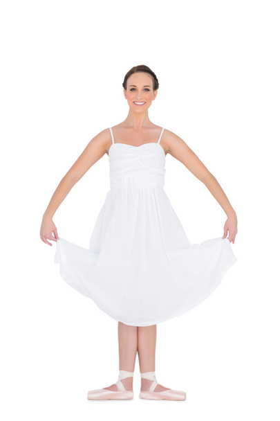 Cheerful young ballet dancer standing in a pose - Photo, image