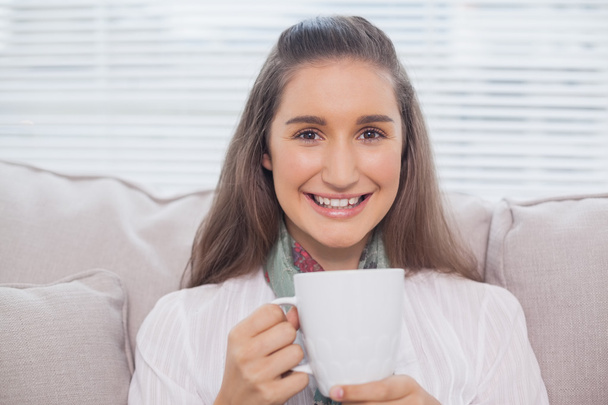 Smiling pretty model holding cup of coffee - 写真・画像