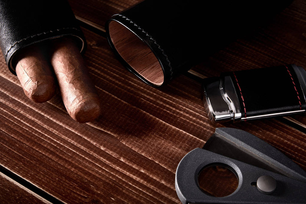 Bodegón con puros cubanos en estuche de cuero negro, cutter y l
 - Foto, imagen