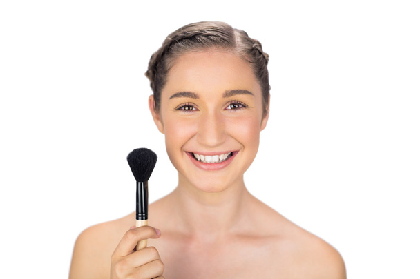 Smiling gorgeous model holding blusher brush - Фото, изображение
