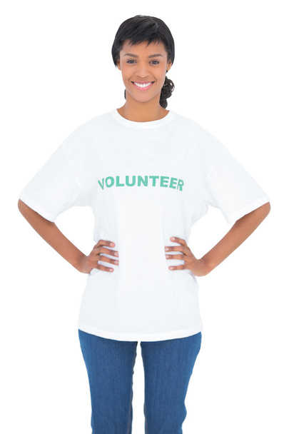 Content black haired volunteer posing with hands on the hips - Foto, Imagen