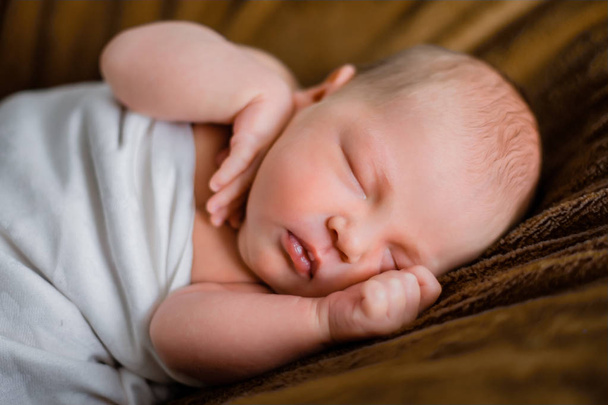 newborn boy is sleeping. brown background - Photo, Image