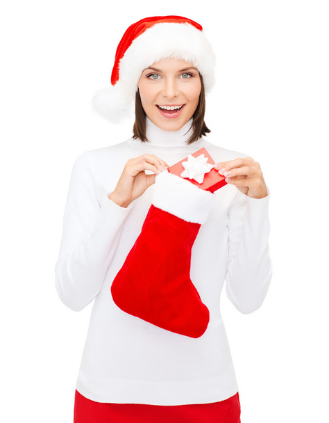 Woman in santa hat with gift box and stocking - Zdjęcie, obraz