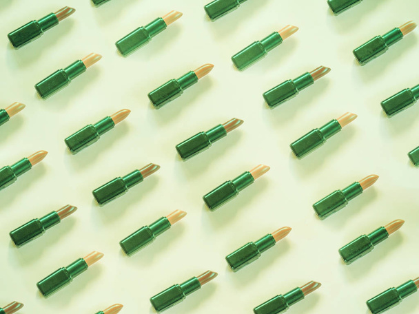 Lipstick pattern on green background - Fotoğraf, Görsel