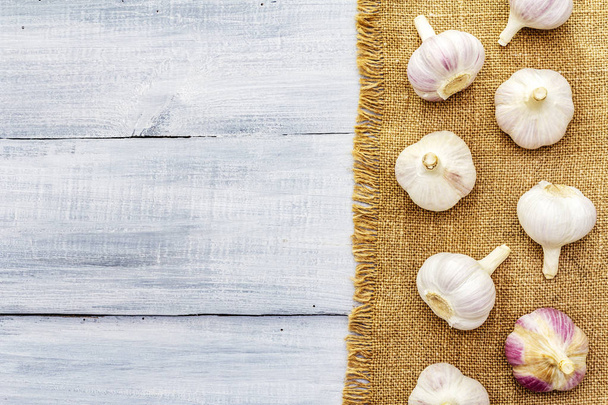 Fresh organic garlic on sackcloth - Fotó, kép