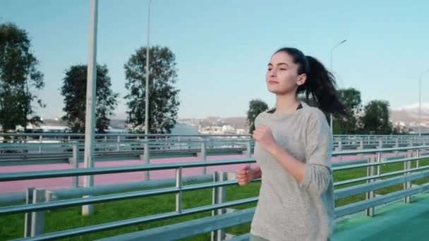 Active and healthy girl jogging outdoors - Felvétel, videó