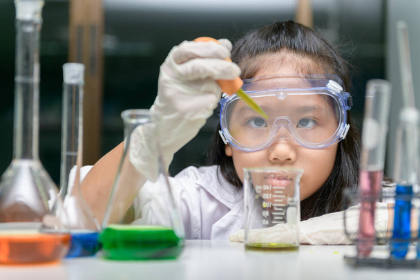  Malá dívka na sobě bezpečné brýle dělat experiment  - Fotografie, Obrázek