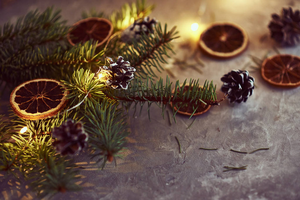 Christmas decorations with garland lights, pine cones and fir tr - Photo, image