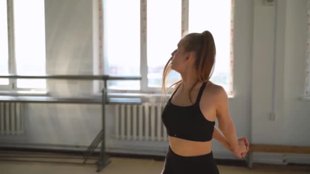 Young girl engaged rhythmic gymnastic in gym - Materiał filmowy, wideo