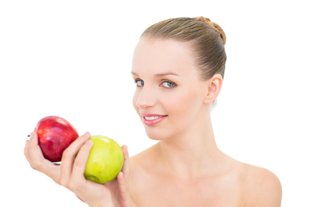 Cheerful pretty blonde model holding two apples - Foto, imagen