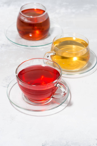 assortment of tea in glass cups, vertical top view - Foto, Bild