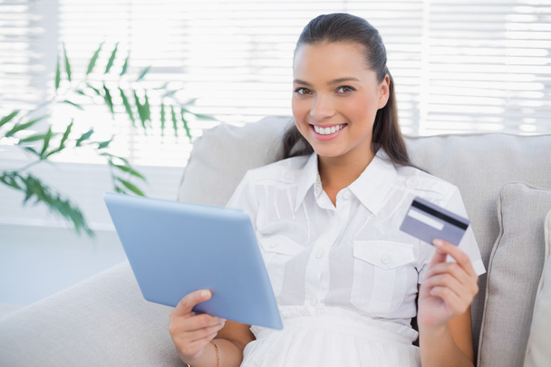 Smiling cute woman buying online using her tablet pc - Fotoğraf, Görsel