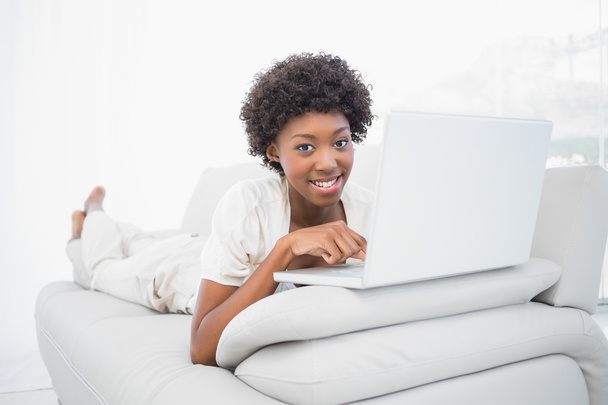 Happy pretty brunette using her laptop - Foto, afbeelding