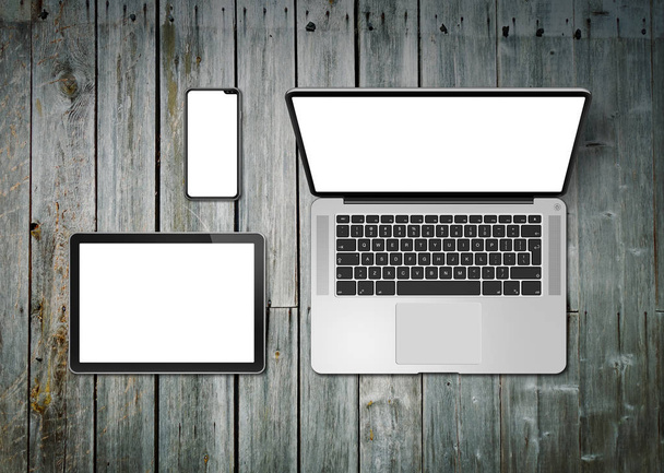 Laptop, tablet and phone set mockup on a wooden background. 3D r - Foto, Imagen