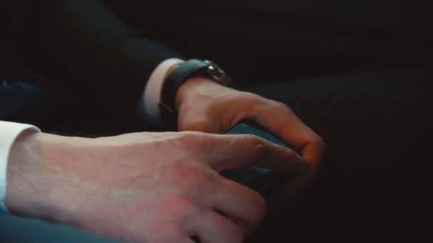 man in suit sits with mobile phone in metro coach close view - Materiał filmowy, wideo