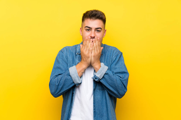 Young handsome man over isolated yellow background with surprise facial expression - Foto, immagini
