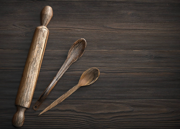 Old wooden spoon and rolling pin on rustic wooden table - Photo, Image