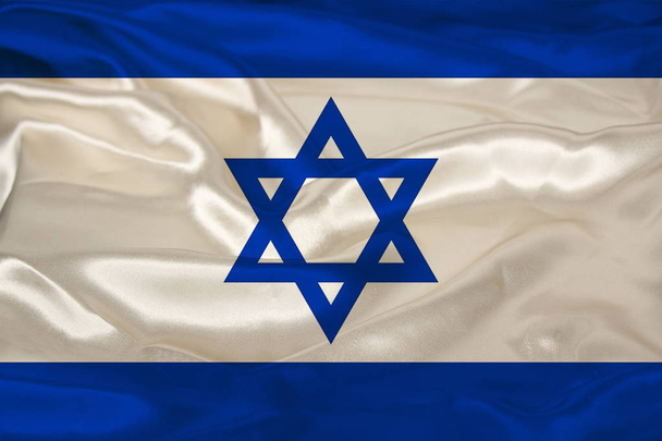 photo of the beautiful colored national flag of the modern state of Israel on textured fabric, concept of tourism, economics and politics, closeupof travel, economy and state policy, illustration - Foto, Imagem