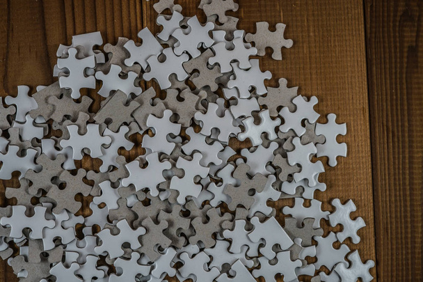 White jigsaw puzzle that has been placed on a desk - Photo, Image