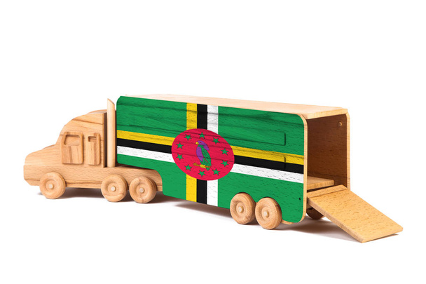 Close-up de um caminhão de brinquedo de madeira com uma bandeira nacional pintada Dominica. O conceito de exportação-importação, transporte, entrega nacional de mercadorias
  - Foto, Imagem