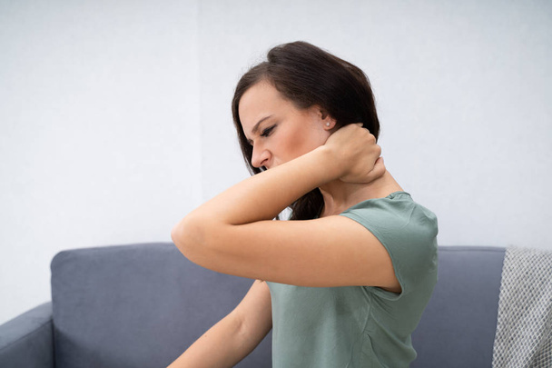 Woman Having Neck Pain Sitting At Home - Foto, imagen