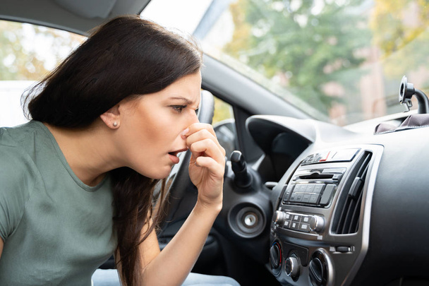 Woman Covering Her Nose From Bad Smell Inside The Car - Foto, Imagem