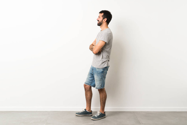 A full-length shot of handsome man with beard in lateral position - Photo, Image
