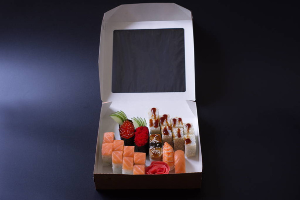 rolls with seafood and cheese from Japanese cuisine are in the box for delivery - Fotó, kép