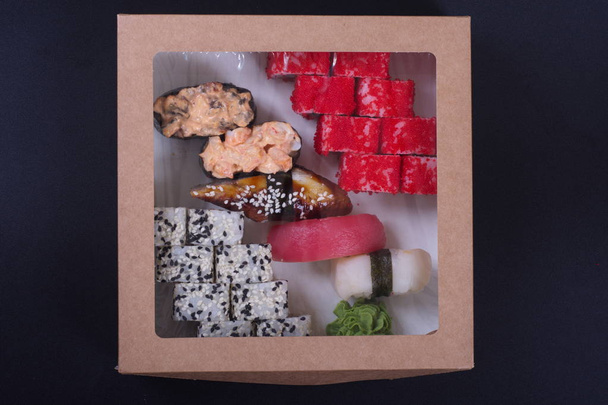 rolls with seafood and cheese from Japanese cuisine are in the box for delivery - Photo, image