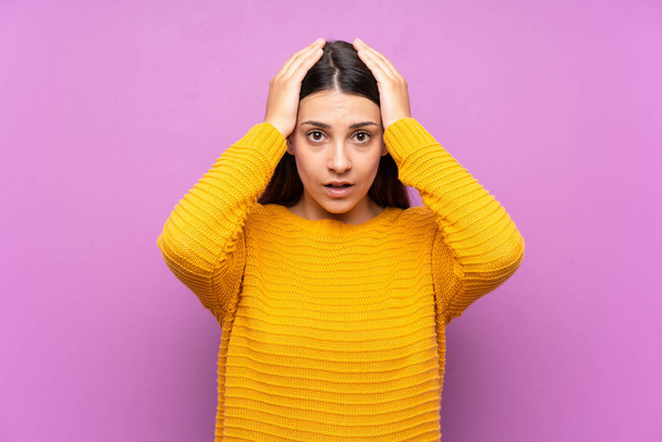 Young woman over isolated purple background with surprise facial expression - Foto, afbeelding