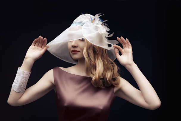 Beautiful lady in silk dress and wide hat posing - Zdjęcie, obraz