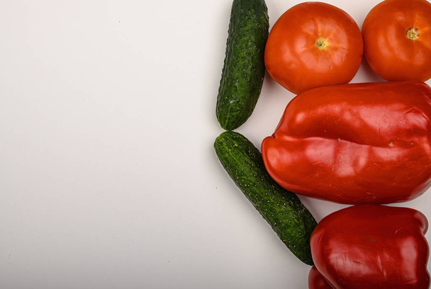 Tomato, cucumber and sweet pepper on white background. Healthy diet. Fitness diet. Copy space. - 写真・画像