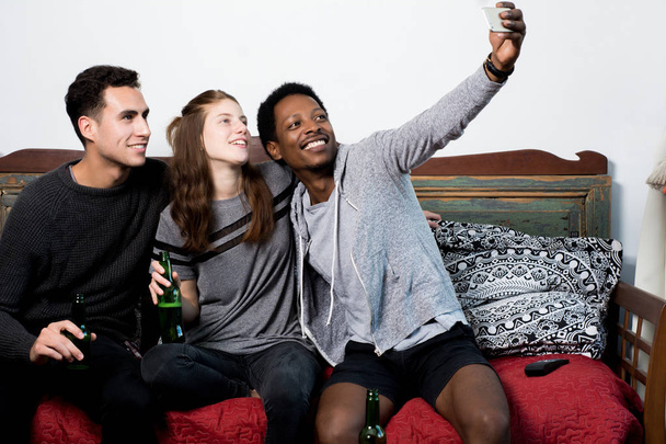 Multicultural friends making a selfie - Foto, Imagen
