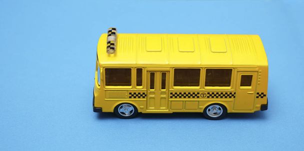 toy of yellow bus isolated on blue background - Photo, Image